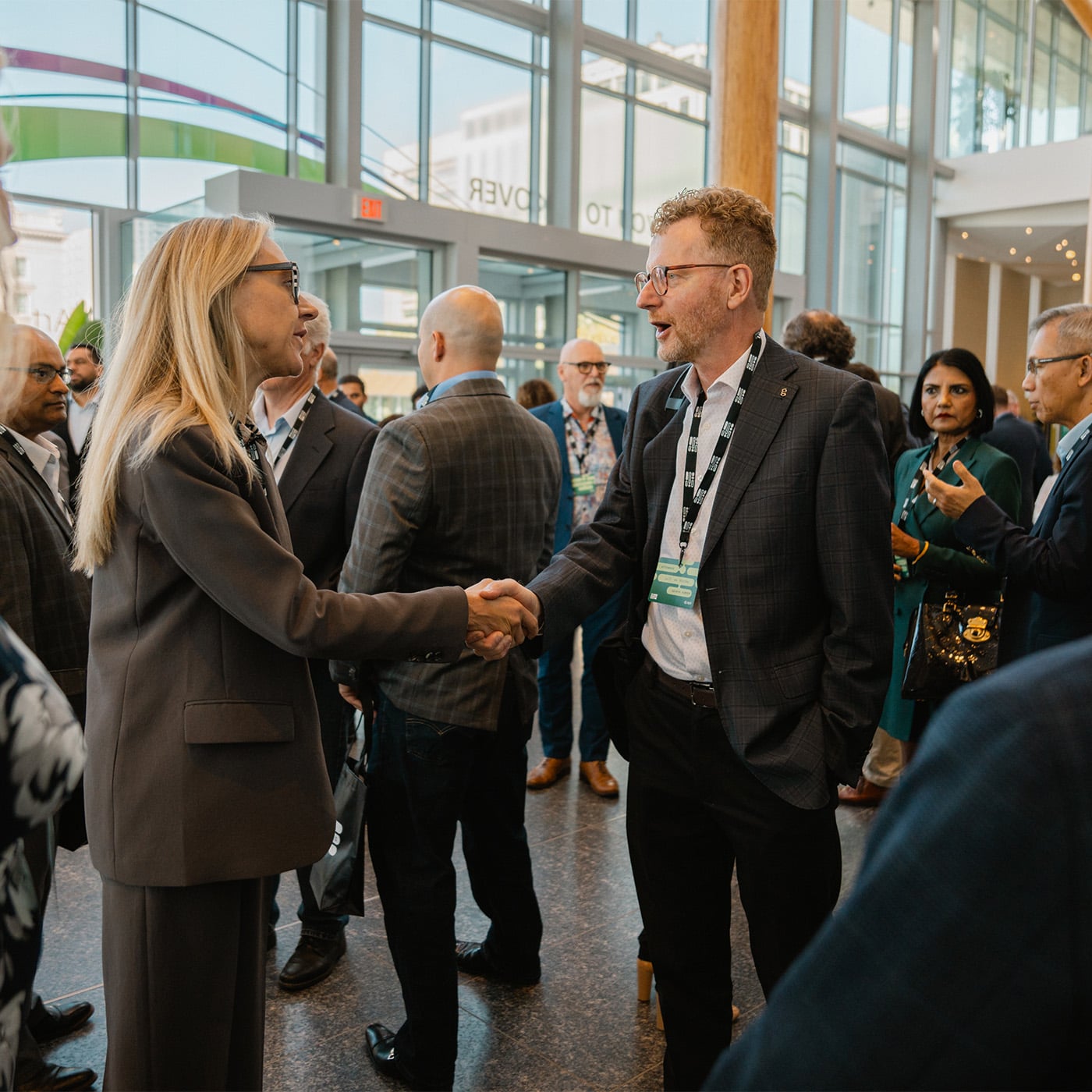 Industry professionals shaking hands at conference
